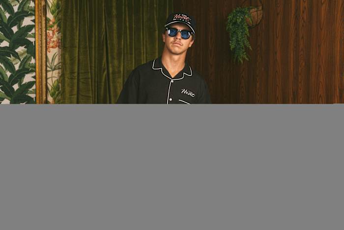 A model wears black Duvin apparel.